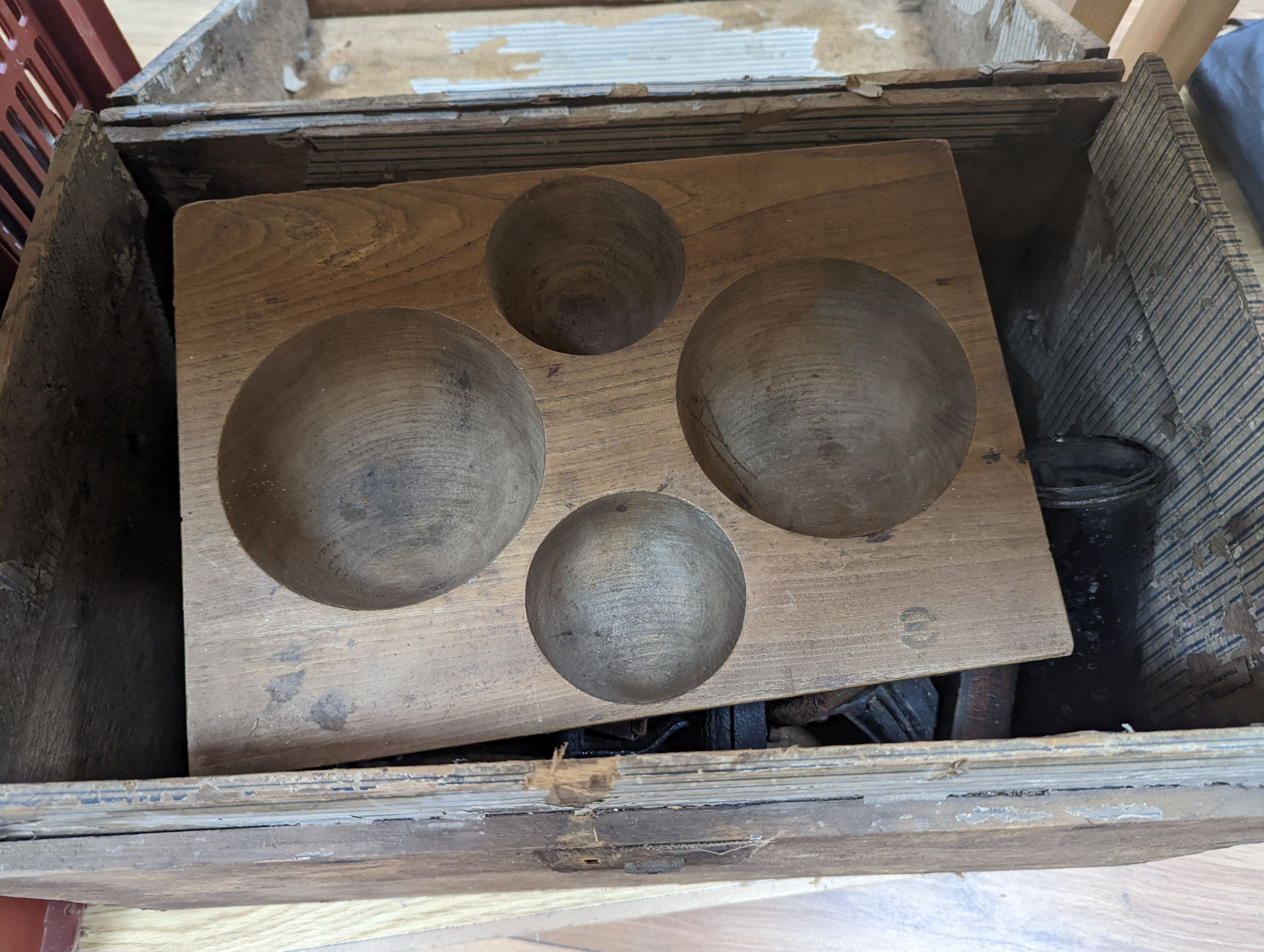 A domed trunk containing flat irons, elm cash-tray etc